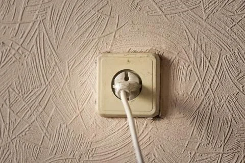 The plug is in the outlet Stock Photos