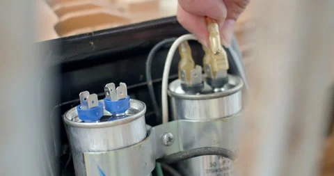 Plug the power cord into the capacitor.Motor capacitor is water-soaked. Stock Footage 307893163