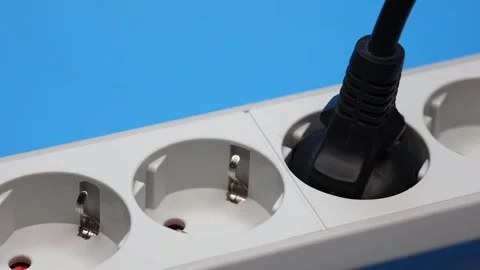 Plug In The Socket Of An Electric Extension Cord On Blue Background. Panning Dol Stock Footage 243748744