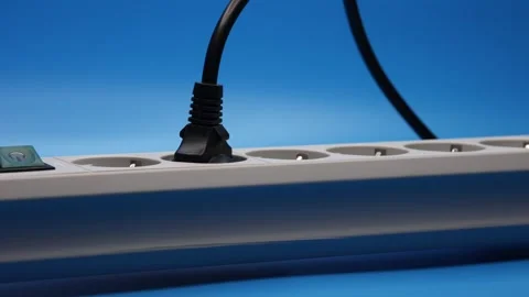 Plug In The Socket Of An Electric Extension Cord On Blue Background. Panning Dol 스톡 동영상 244541434