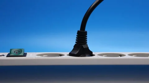 Plug In The Socket Of An Electric Extension Cord On Blue Background. Panning Dol 스톡 동영상 246383815