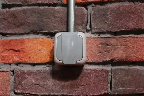 Plug socket with stone background in a cafeteria. 스톡 사진