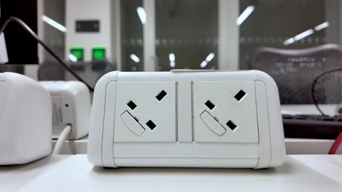 Plug sockets on an office desk providing power Stock Footage 325838887