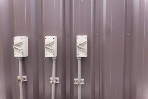 Plug on the wall outside modern building Stock Photos