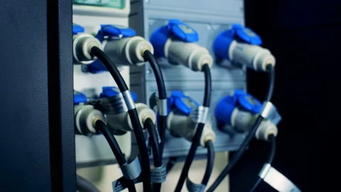 Plugged-in cables providing electricity to computer mechanisms Video stock 99085174