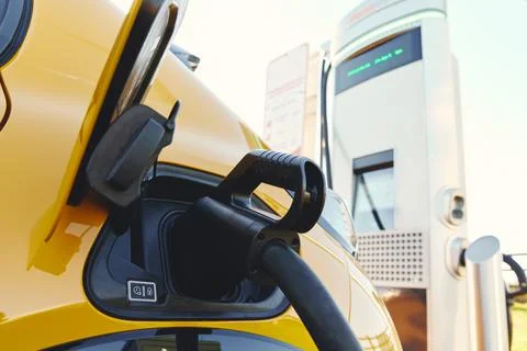 Plugged in electric car in at a EV charging station Stock Photos