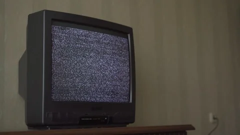 Plugged to main power TV set with flashing screen at wall Stock Footage 122943309