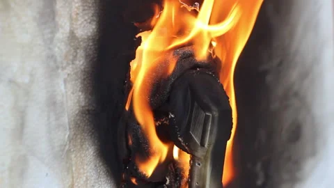 Plugged into the socket, the plug from the appliance burns and melts from overvo Stock Footage 154117119