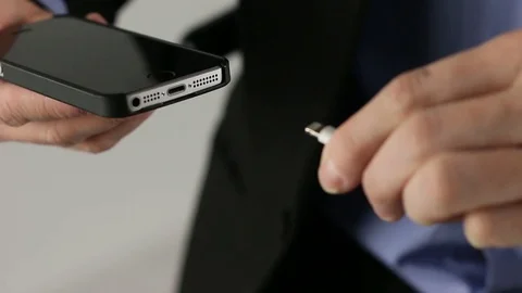 Pluggin in charging cabple (Iphone SE) close up Stock Footage 74818847