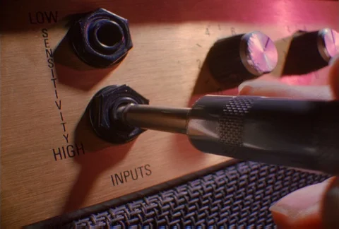 Plugging in an amplifier on an electric guitar, close-up Stock Footage 86885465