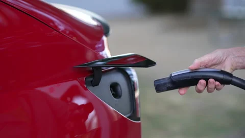 Plugging In and Charging a Red Electric Vehicle Stock Footage 206826963
