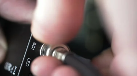 Plugging in and removing a BNC cable for an SDI video connection. Stock Footage 66205651