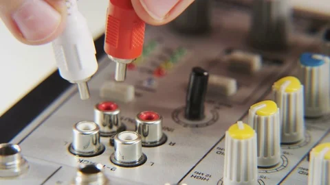 Plugging and Unplugging Red and White Cables Stock Footage 70998349