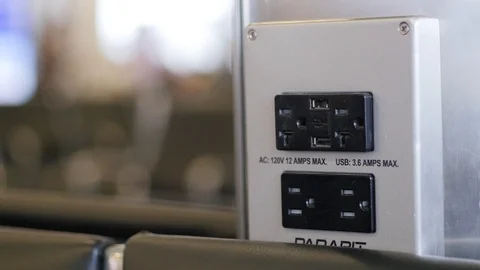 Plugging and unplugging usb cord at airport Stock Footage 105937499