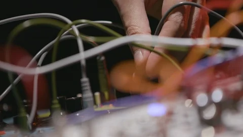 Plugging and unplugging wires sound board slow motion Stock Footage 109425454