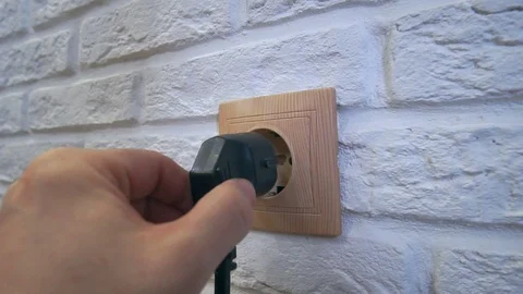 Plugging the appliance into a wall outlet Stock Footage 120287427