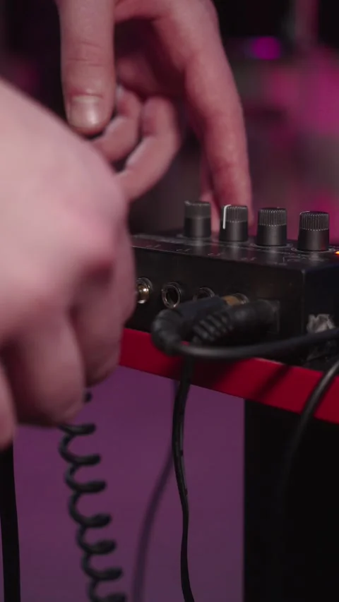 Plugging audio cable into headphone amplifier in recording studio Video stock 332978954