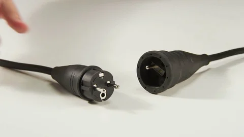 Plugging Black Cable to an Extension Cord Stock Footage 70999462