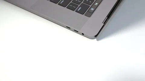 Plugging in a black USB-C / Type C cable to a modern notebook Stock Footage 95126637