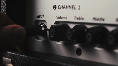 Plugging cable into the guitar amp Stock Footage 156636296