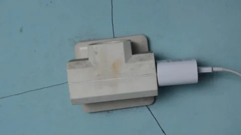 Plugging the charger and night light into the socket Stock Footage 287958808