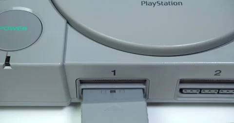 Plugging in a controller to a vintage 1990's Sony PlayStation Stock Footage 161502258