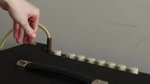 Plugging in a cord into an amplifier Stock Footage 333463156