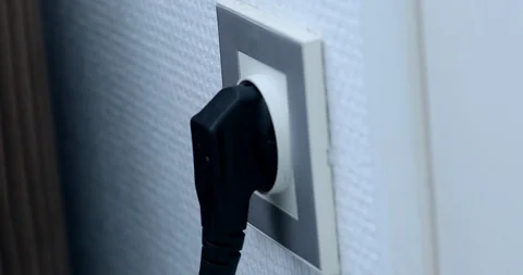 Plugging Different Power Plugs Into Wall Outlet Video stock 101173365