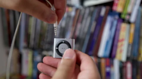 Plugging Earphones to Ipod Shuffle Stock Footage 45607249