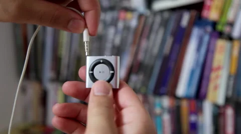 Plugging Earphones to Ipod Shuffle Stock Footage 45607351