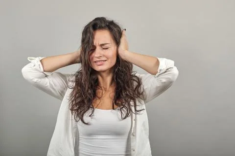 Plugging ears fingers doesn't want to hear, covered auricle hands, displeased Stock Photos