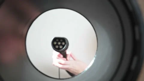 Plugging in an electric car at outlet socket. Stock Footage 198508549