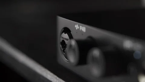 Plugging in electric guitar jack in audio interface at home music studio Stock Footage 107990423