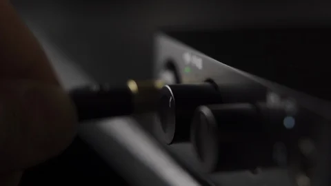 Plugging in electric guitar jack in audio interface at home music studio Stock Footage 107990865