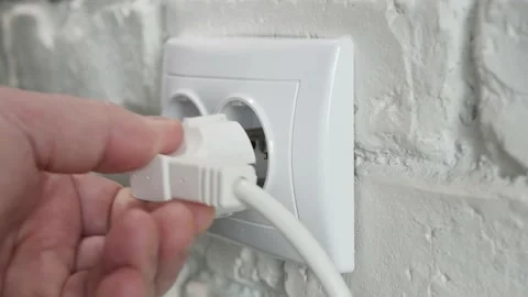 Plugging in an Electrical Power Cord with Plug to a Wall Socket from the Office. Stock Footage 164433755