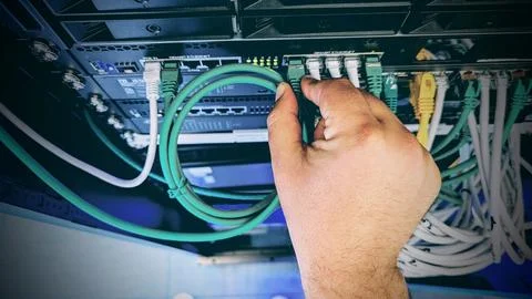 Plugging in an ethernet cable Stock Photos
