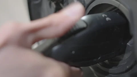 Plugging in an EV Electric Vehicle Battery charger Stock Footage 275549062