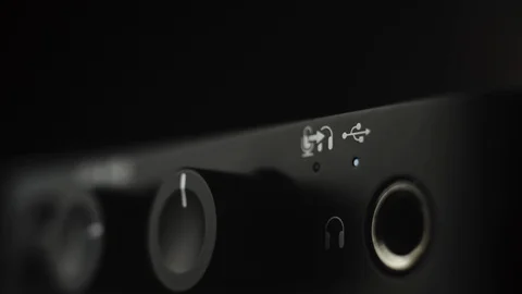 Plugging in headphone jack in audio interface at home music studio Video stock 107983077