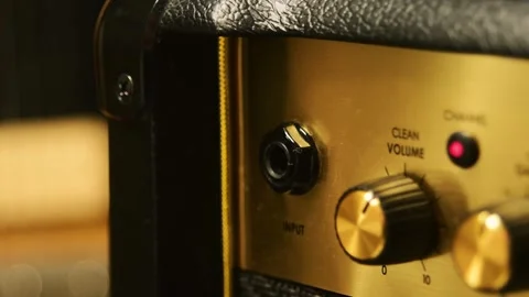 Plugging a jack into a guitar amplifier Stock Footage 277796053
