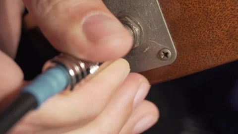 Plugging a jack into old electric guitar Stock Footage 93998345