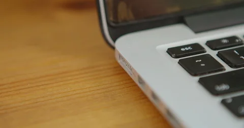 Plugging in Laptop Power Cable and Turning on Laptop Stock-Footage 127675178