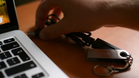 Plugging in Ledger cold hardware Bitcoin cryptocurrency wallet entering PIN code 스톡 동영상 93944502