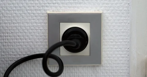 Plugging Manyt Power Plugs Into Wall Outlet Stock Footage 101181933