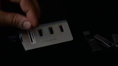 Plugging in Micro SD Card into Multi-Card Reader Hub Video stock 89636174
