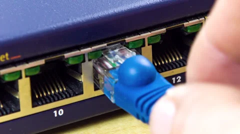 PluggIng in a network cable with blue cable Stock Footage 32243181