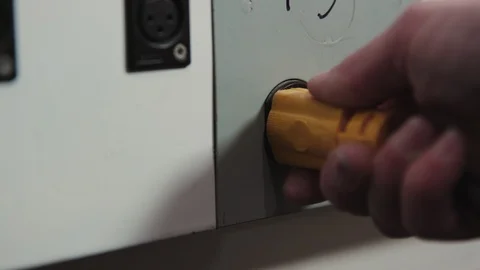 Plugging in a power cable into a power outlet on an electrical board 库存影片 89501736
