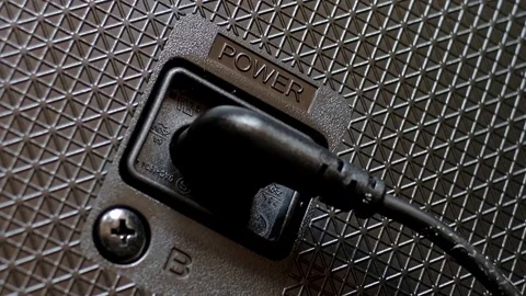  a plugging in a power cord into the socket on the tv. Stock Footage 73997212