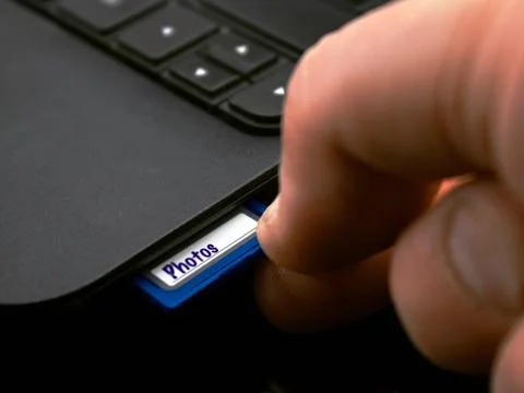 Plugging in sdhc memory card Stock Photos