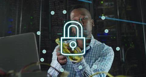 Plugging tech in blue shirt behind glass in data center, organizing yellow 写真素材