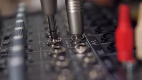 Plugging TRS jacks in an audio mixer Stock Footage 80867548